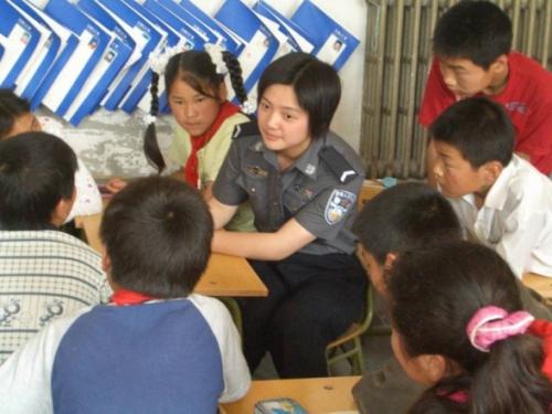 Volunteer from Chinese People's Public Security University with migrant children – part of an education programme supported by the Narada Foundation.