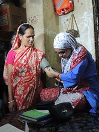 A microinsurance client receives a health check-up in Bangladesh