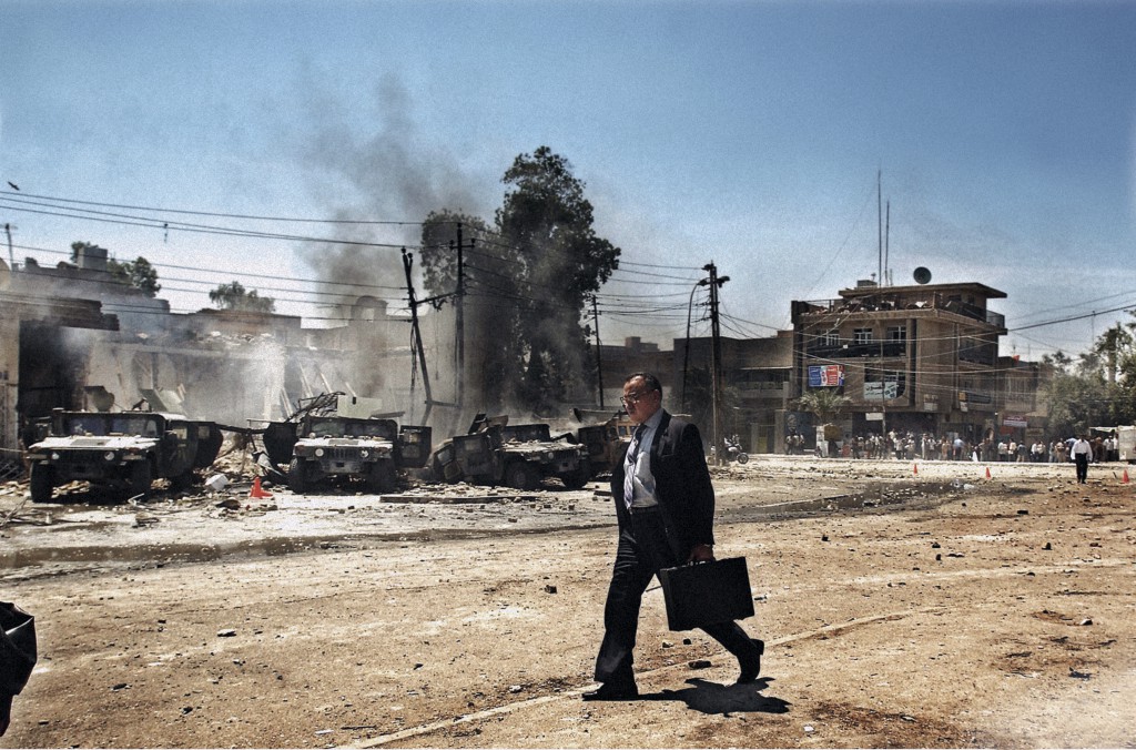 Baghdad, April 2004. An Iraqi man walks by the scene of an attack on US Army Humvees that caused several American casualties in the Al-Waziriyah neighbourhood of Baghdad. Photo by Moises Saman/MAGNUM