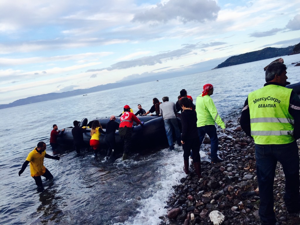Volunteers pulling out a boat on the shore after having removed all the passengers safely. Credit Sofia Kouvelaki