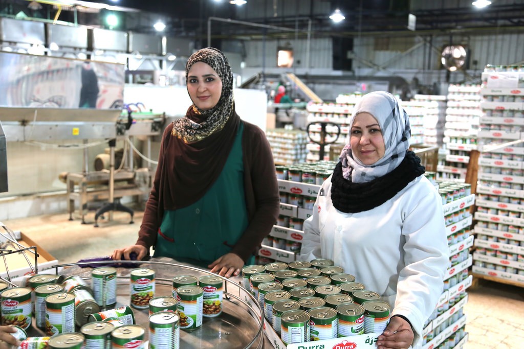 Anood from Jordan and Salma from Syria, working together in a Syrian-owned food processing factory Jordan.