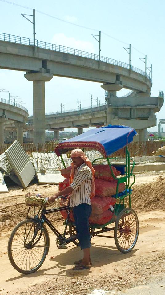 Two faces of Delhi: flyover construction and cycle rickshaw delivery man (left). Right: art installation in a five-star hotel.