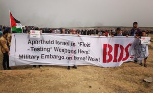 Palestinians in Gaza participating in the Great Return March in April 2018 express support for BDS. Photo cdredit: bdsmovement.net